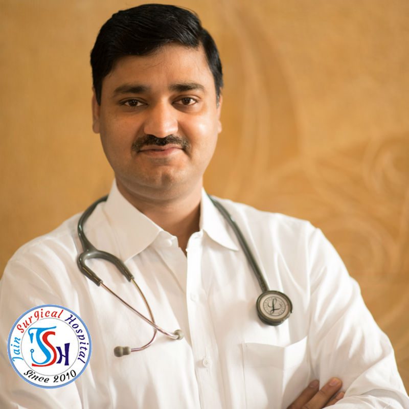 A doctor, Dr. R Soni, wearing a stethoscope, examining a patient's health.